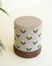 Grey Upholstered Ottoman with Embroidered Detail and Carved Wood Base